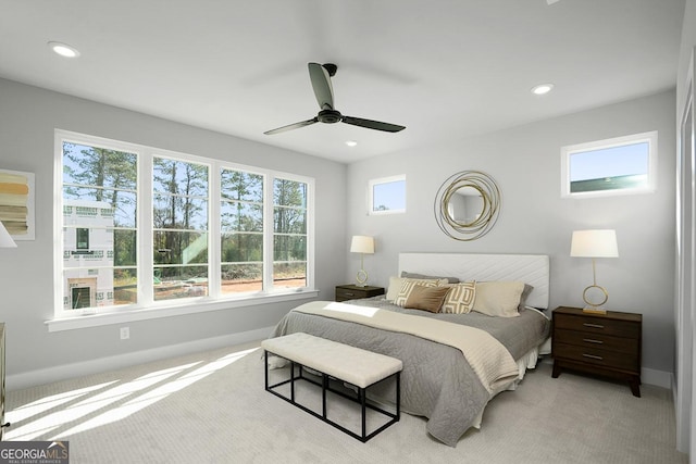 bedroom featuring light colored carpet and ceiling fan