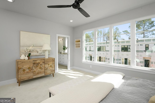 carpeted bedroom featuring ceiling fan and ensuite bathroom