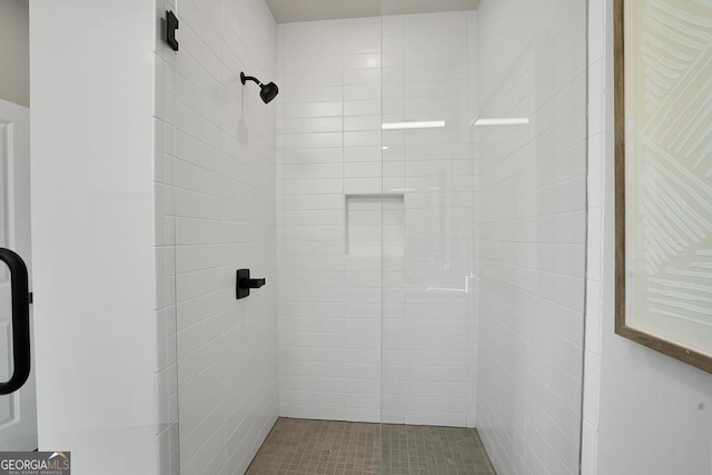 bathroom with a tile shower