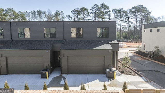 view of front of house with a garage and central AC unit