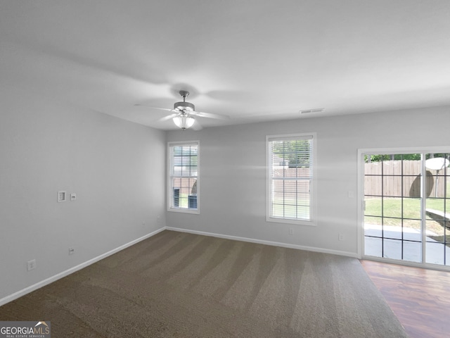 carpeted empty room featuring ceiling fan