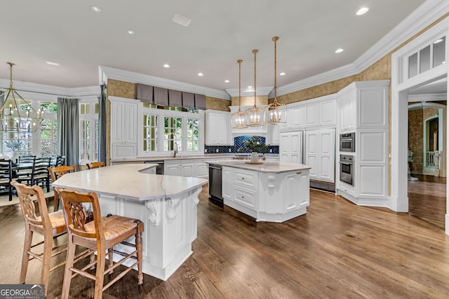 kitchen with hardwood / wood-style flooring, white cabinets, and a spacious island