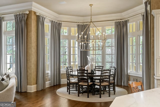 dining area with dark hardwood / wood-style floors, plenty of natural light, and a chandelier