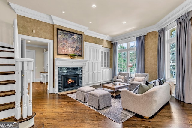 living room with crown molding, dark hardwood / wood-style flooring, and a fireplace