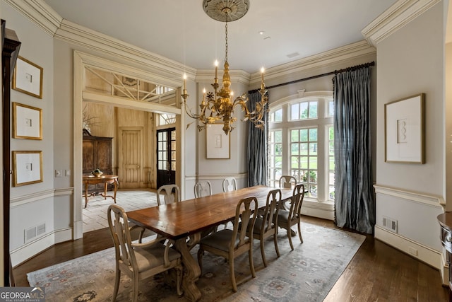 dining area featuring crown molding, dark hardwood / wood-style floors, and a notable chandelier