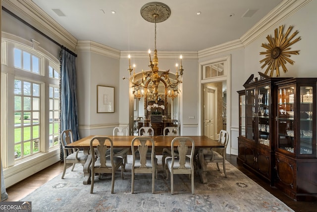 dining room with crown molding, wood-type flooring, a notable chandelier, and baseboard heating