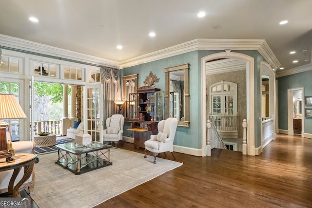 living area with dark hardwood / wood-style flooring and ornamental molding