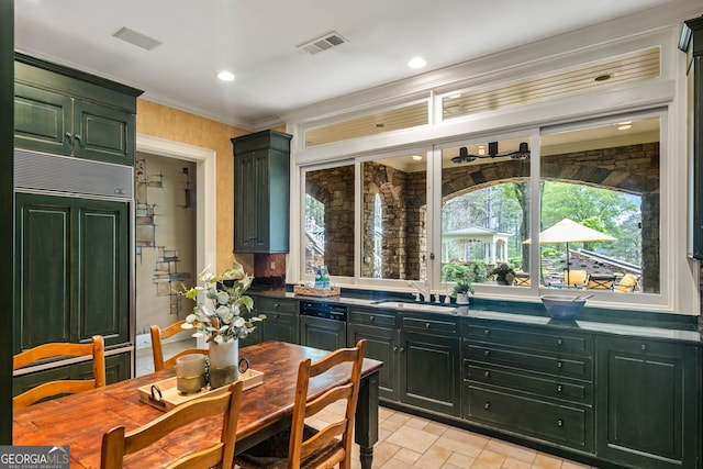 kitchen with a healthy amount of sunlight, sink, light tile floors, and paneled refrigerator