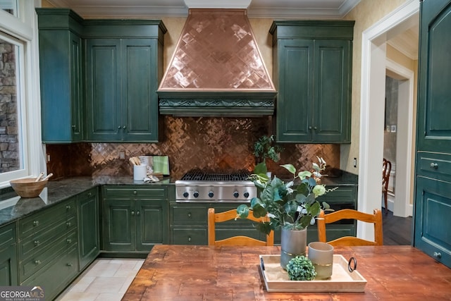 kitchen featuring butcher block countertops, tasteful backsplash, custom exhaust hood, and green cabinets