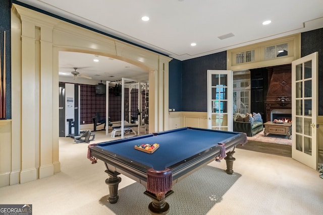 recreation room featuring a large fireplace, french doors, billiards, light colored carpet, and ceiling fan