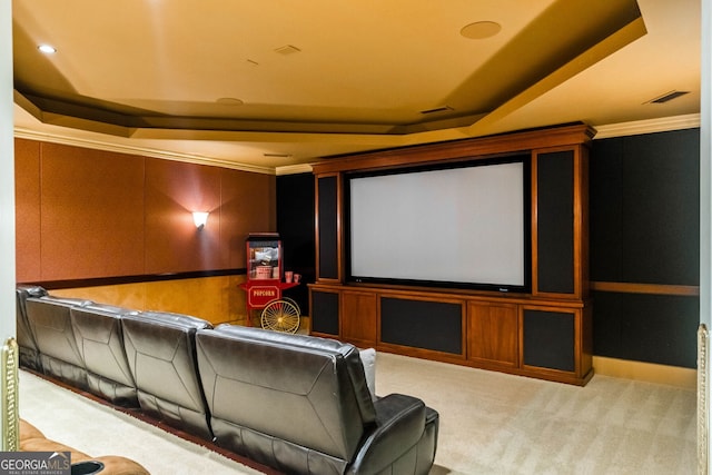 home theater with carpet flooring, crown molding, and a tray ceiling