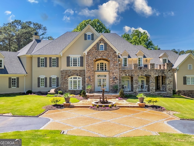 view of front facade featuring french doors and a front yard