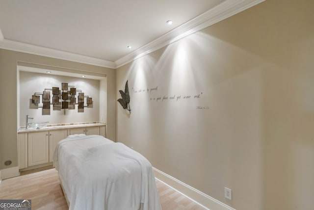 bedroom with light hardwood / wood-style floors and crown molding