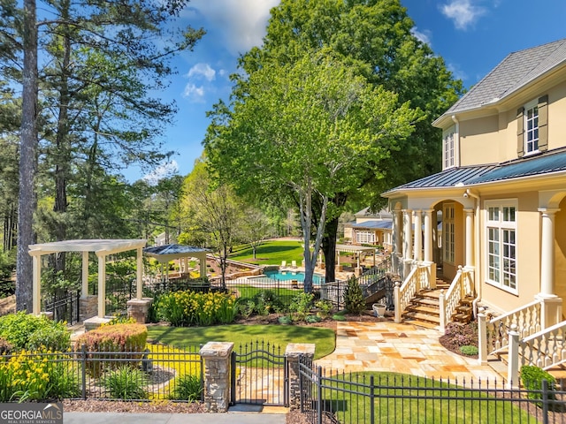 exterior space featuring a front yard and a fenced in pool