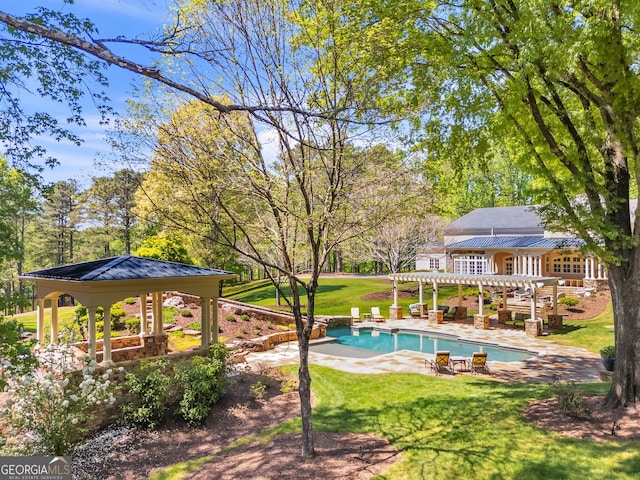 view of pool with a patio, a pergola, a gazebo, and a lawn