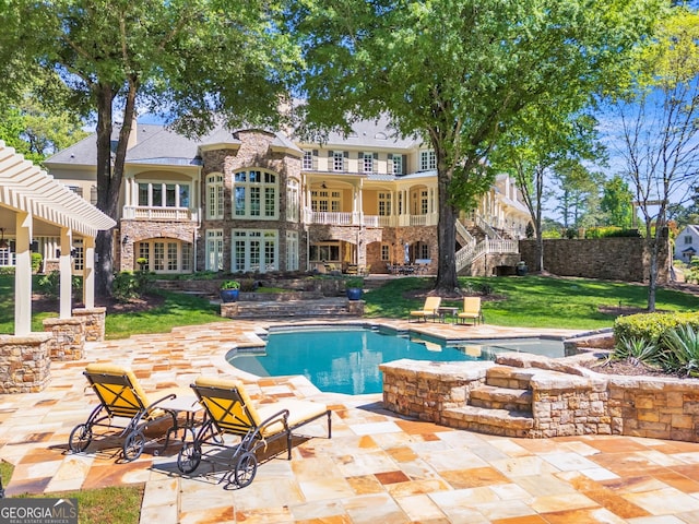 view of pool with a hot tub and a patio