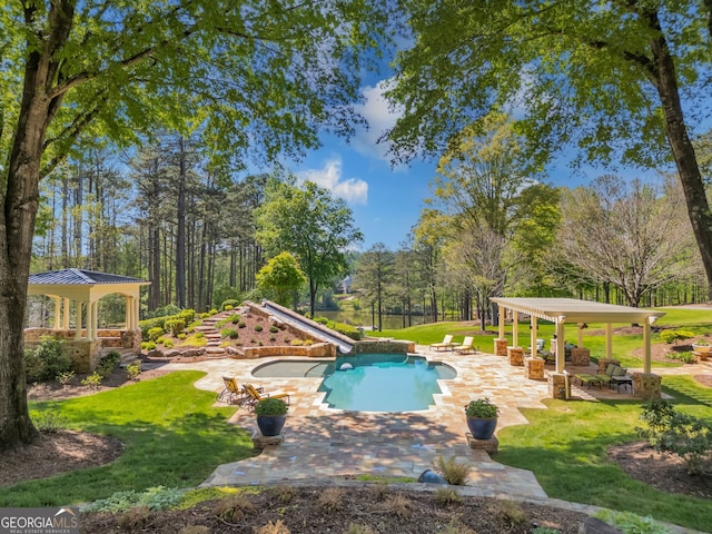 view of swimming pool with a patio area, a pergola, a water slide, a gazebo, and a yard