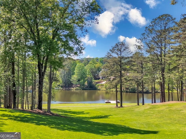 view of home's community featuring a yard and a water view