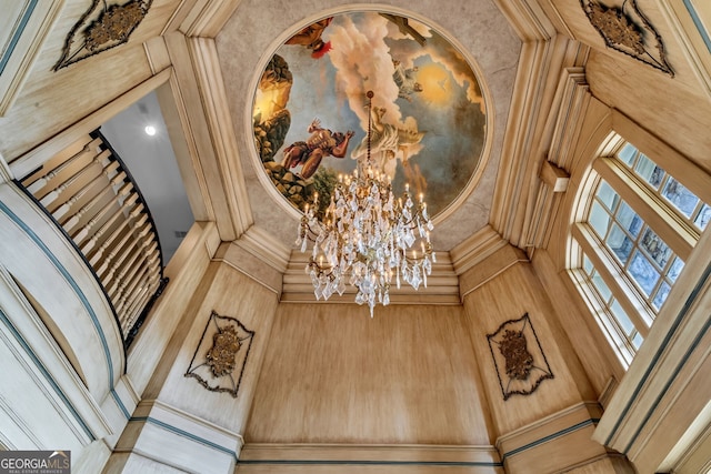 room details featuring ornamental molding and a notable chandelier