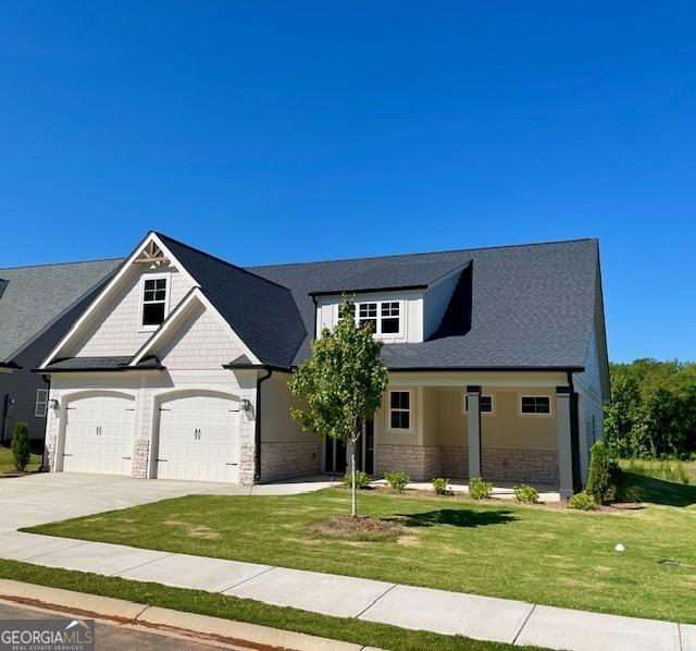 view of front of home with a garage and a front yard