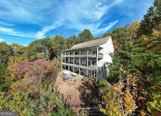 back of house featuring a balcony