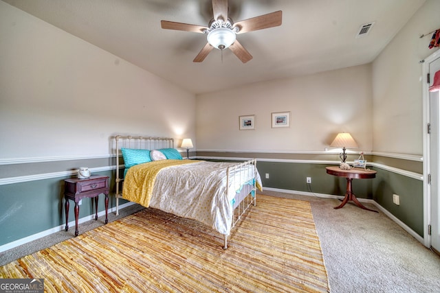 carpeted bedroom featuring ceiling fan and radiator