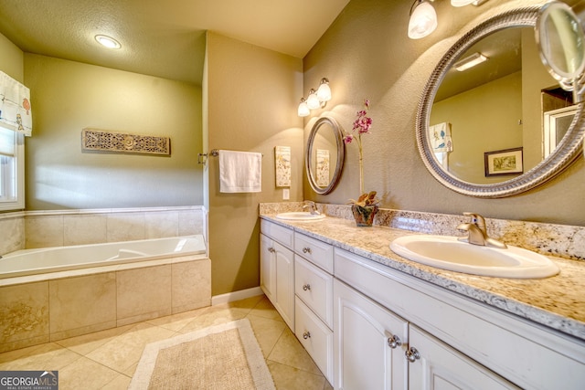 bathroom featuring large vanity, a relaxing tiled bath, tile floors, and double sink