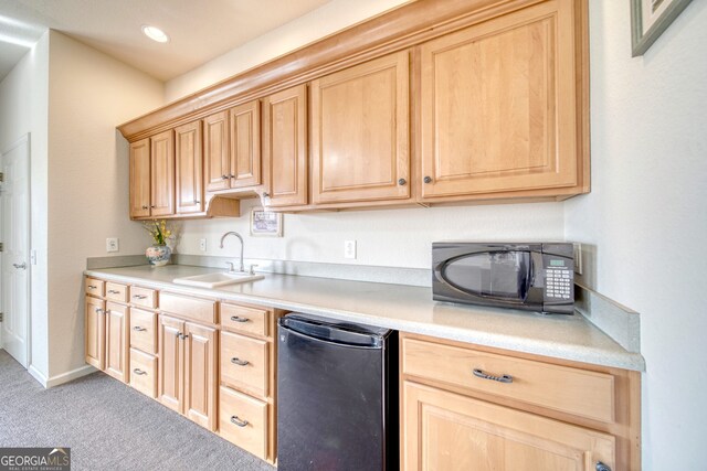 kitchen with sink, carpet floors, and light brown cabinetry