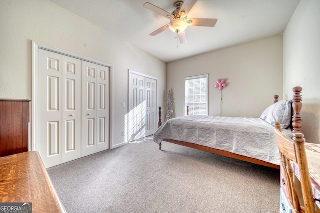 bedroom featuring ceiling fan, carpet flooring, and two closets