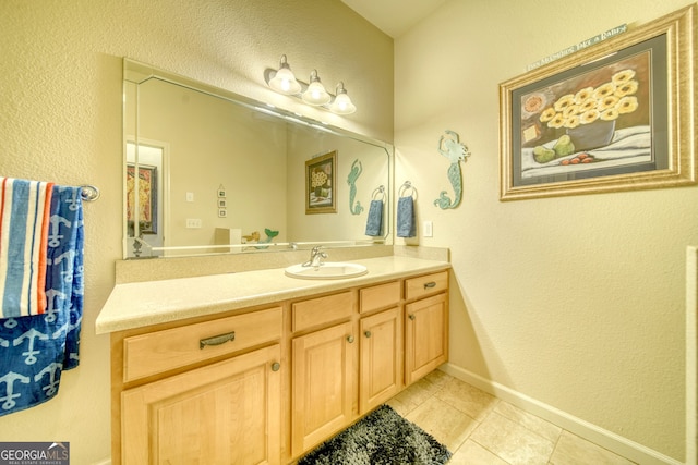 bathroom with tile flooring and vanity