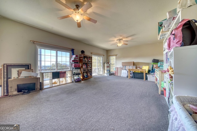 recreation room with a wealth of natural light, ceiling fan, and carpet flooring