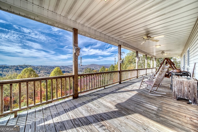 deck featuring a mountain view and ceiling fan