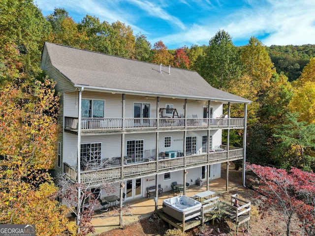 rear view of house featuring a balcony and a patio area