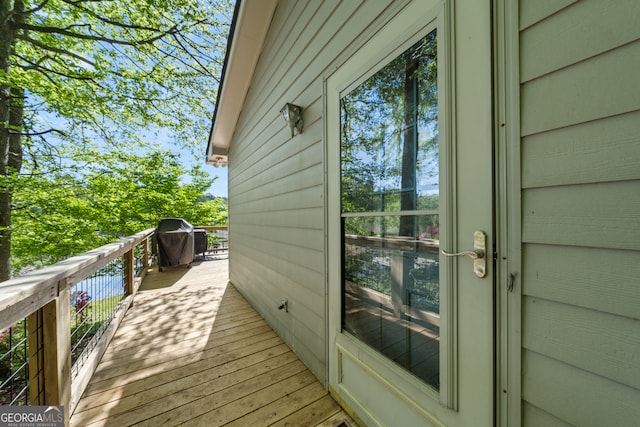 wooden deck with a grill