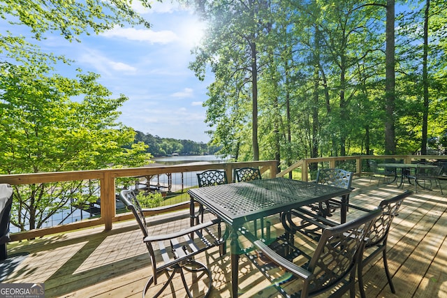 wooden terrace featuring a water view