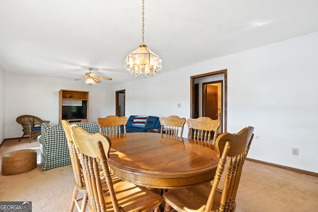 dining space with light colored carpet and ceiling fan with notable chandelier