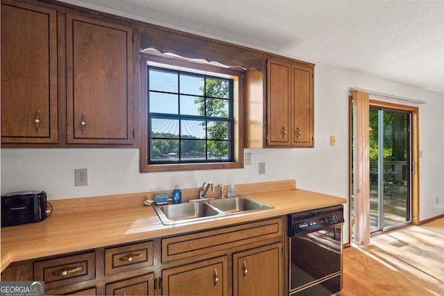 kitchen with light colored carpet, dishwasher, and sink