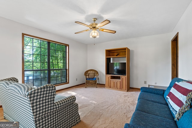 carpeted living room with ceiling fan