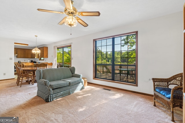 living room featuring light carpet and ceiling fan