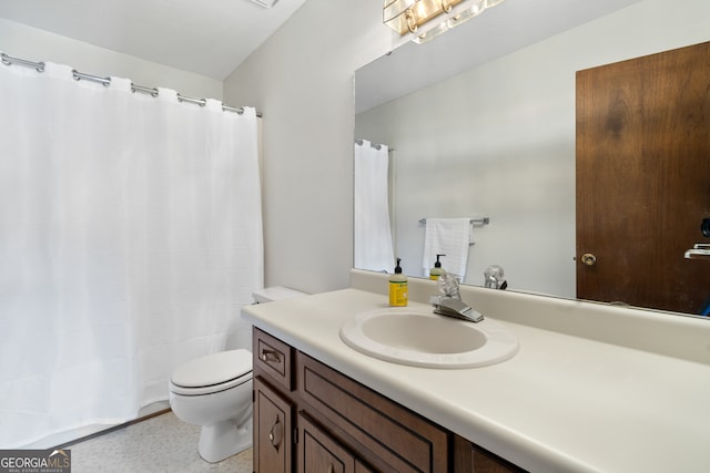 bathroom with vanity with extensive cabinet space and toilet