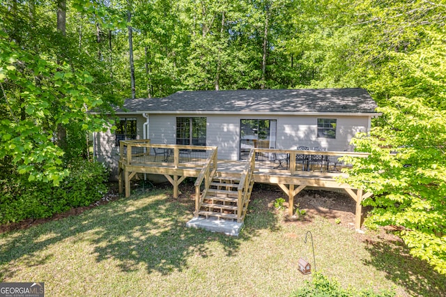 back of property featuring a yard and a wooden deck