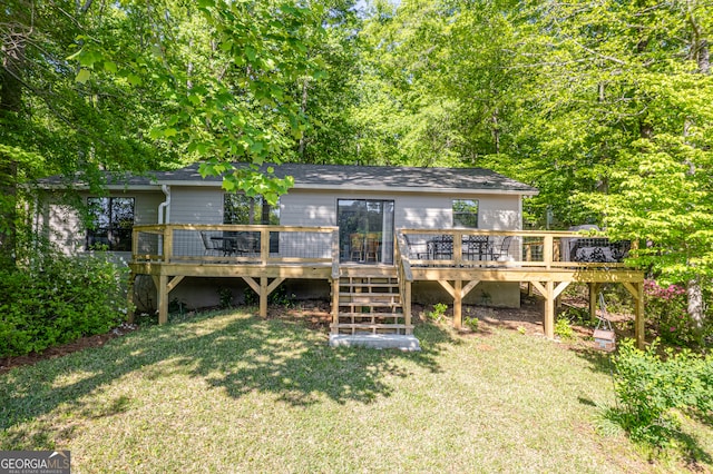 back of house with a yard and a wooden deck