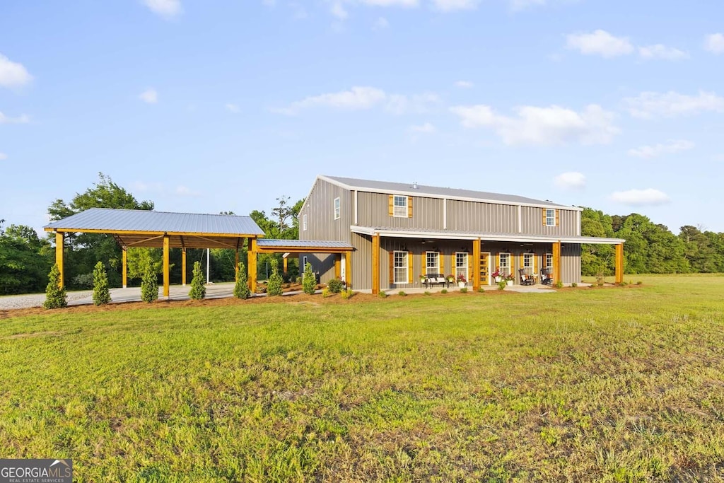 rear view of property with a yard