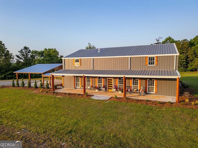 back of house featuring a patio area and a yard