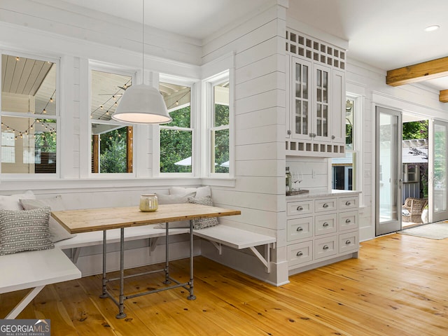 kitchen featuring pendant lighting, wood counters, sink, light hardwood / wood-style floors, and stainless steel appliances