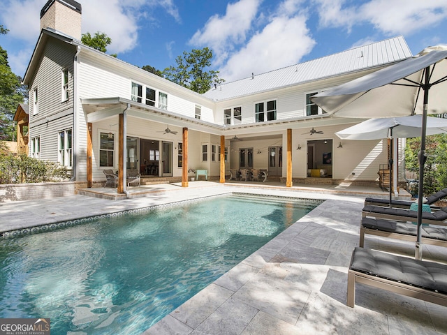 back of property with ceiling fan and a patio area