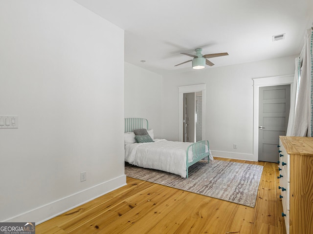 living room featuring wood-type flooring and ceiling fan