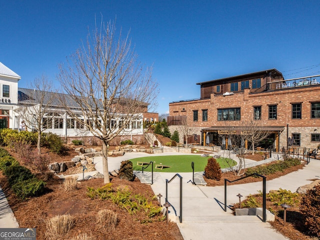 view of yard featuring a playground, a trampoline, and a fire pit