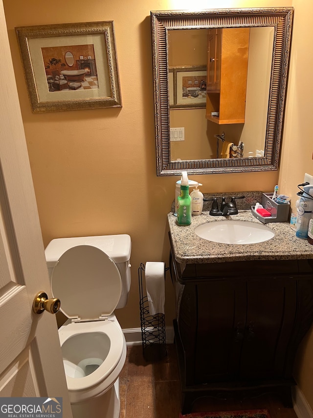 bathroom featuring vanity and toilet