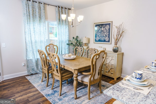 dining space featuring an inviting chandelier and dark wood-type flooring